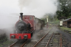... before emerging through a cloud of steam with shortened train ...