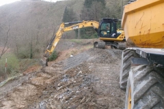 ... while adjacent, Richard pushes down sticky sub-soil to enable him to trim the very top of the new embankment ...