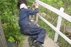 Phil relaxes afterwards, priming the new (and old) woodwork on the steps handrail leading down to the Carriage Shed …