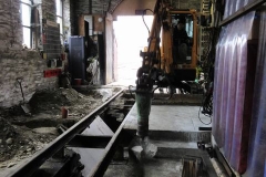 ... which is soon put to work, breaking out the concrete floor on the west side of the outermost pit in the Engine Shed, to adapt the Shed for servicing a second steam locomotive.