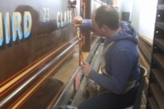 In the Carriage Shed, Glenn is lettering carriage No. 23 ...