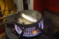 White metal is then heated in the wok ...