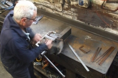 … while Bob bends rebar for the carrying handles.