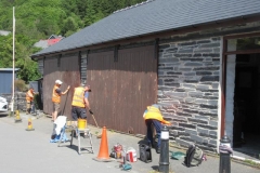 Nearby, the Coach House doors get a good rub down in anticipation of re-painting.