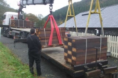 Friday, 5.11.2021. New treated softwood sleepers are transferred from road to rail at Maespoeth, destined for use at Corris Station ...