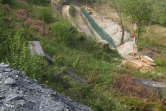 To give some perspective to the overall scheme, this is the view from the (temporary) slate waste deposited on the south side of the Nant Goedwig last year. The culvert is the structure just beyond the tipped slate waste, with the new gabion wall stretching away in the middle distance. Disappearing under the tree canopy beyond, is the access track to the site and just beyond the end of that,  is the end of the headshunt in Maespoeth Yard.