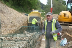 Wednesday, 13.5.2020. Dai is wary of the camera as he cuts bracing wire, and Richard tops up the sub-base by hand to obtain the necessary level for the next lift of gabions.