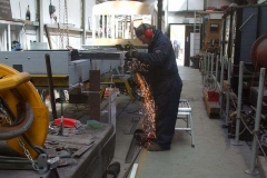 … while Adrian continues his work preparing and welding floor support angles to the frames of carriage No. 24 …
