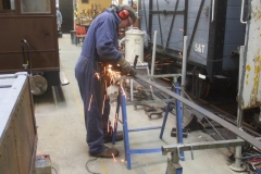… while Adrian cuts bar to form “L’s”, which when welded together and dressed off…