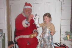 ... with one little girl having dressed up to see Santa, but her hands are too full to receive her present!