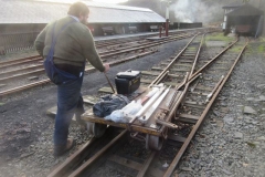 Tuesday, 16.1.2024. Sam trolleys some recently acquired spare levers towards the Signal Box ...