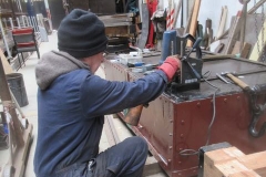 Adrian drills holes in the floor of the Drop-Side waggon body for holding-down bolts ...