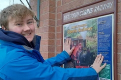 Sunday, 24.3.2024. It's that time of year again as the forthcoming Easter weekend sees the first passenger trains of the season on the Corris railway and member Jack makes his annual trip to Wharf Station with dad John to display the new Corris poster.