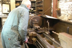 … as Bob turns holes in two plates for use in carriage No. 24.