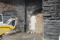 ... while down in Machynlleth, the outer skin of the tramway arch infill has been removed ...