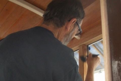 … following which a priming coat of varnish is applied to the internal timber work above seat level …