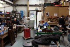 By Saturday mid-morning the scene is very industrious with Dick preparing slats for the seat bases and backs being cut out by Richard. Meanwhile Ian is making full use of the mobile dust extraction unit he created.