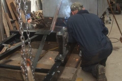 Thursday, 28.7.2022. Adrian turns the frames of waggon No. 203 over to improve access for welding some parts ...