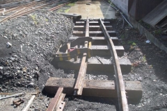 Outside, between hail showers, the fuel siding rails have been laid out, one rail has been curved and the other is being worked on.