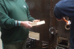... while in the Carriage Shed, Mark examines a piece of wood while Bill prepares ...
