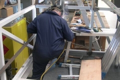 Adrian is welding the seat supports in the north saloon of No. 23 today …
