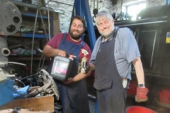 In the Engine Shed, Sam and Joe prepare to lubricate turnouts as part of regular maintenance.