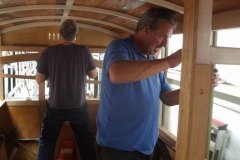 Saturday, 1.9.2018. Peter fits timber sections inside carriage No. 23, while in the background, Andy carries out his exercises!