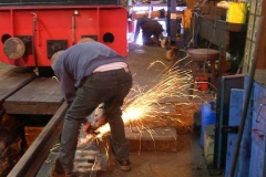 … and then grinding them smooth while the next buffer beam is welded similarly.