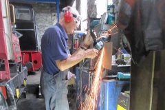 In the Engine Shed, Peter is cutting steel to improve gate closure arrangements.