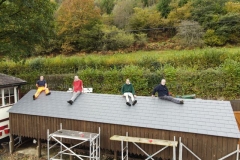 A very satisfied team takes a well earned break before fixing the guttering.