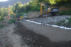 By evening, after completing the layer and rolling it, the new embankment is starting to take shape.