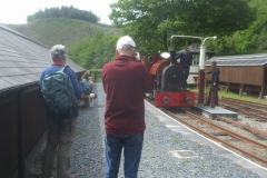 ... with photographers among the passengers taking an interest in the loco being watered on its return.