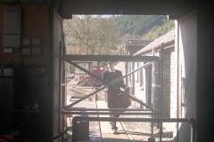 Everything is set up to complete the Engine Shed door height adjustments as Guard John Arnold tidies before the first train heads towards Corris.