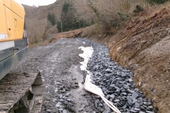 ... while beyond, the next drainage layer has been placed and awaits covering with geotextile.