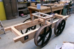 ... until by evening, it has been fitted over the wheelsets with representative brake handle and a crude seat assembled.