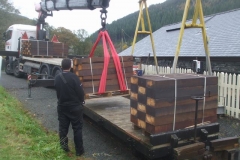 Friday, 5.11.2021. New treated softwood sleepers are transferred from road to rail at Maespoeth, destined for use at Corris Station.