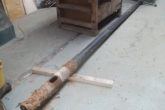 The lamp column from Corris is brought into the Carriage Shed for cleaning and repainting.