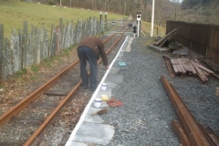 Tuesday, 15.3.2022. Dick re-paints the edge line on the North Platform at Maespoeth ...