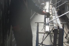 ... while Adrian welds brackets in the Carriage Shed ...