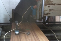 ... while Graham drills holes to fix the floor planks in the P Way van ...