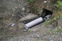 … and gets the base out of the water between old and new culverts (with temporary pipe to keep the new work dry).