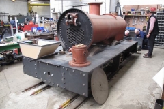 The (wooden) ash pan and the Salter valve equipment are put onto the front of the loco chassis while ...